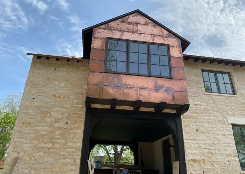 Copper metal panel facade on a stone building for Skylight Installation in East Flat Rock